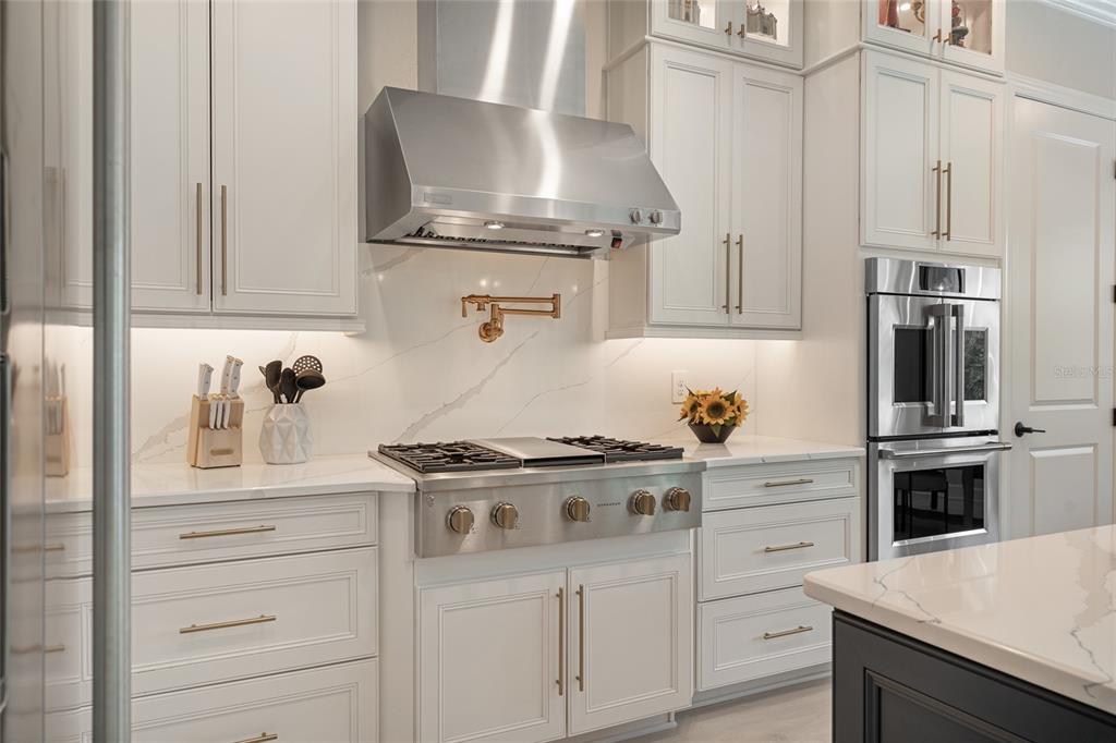 10175 Brocksport Circle Gotha, FL 34734 - Photo 11 of 54 a kitchen with stainless steel appliances granite countertop a stove and a refrigerator
