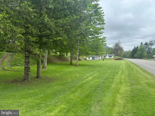 a view of a house with a backyard and a patio