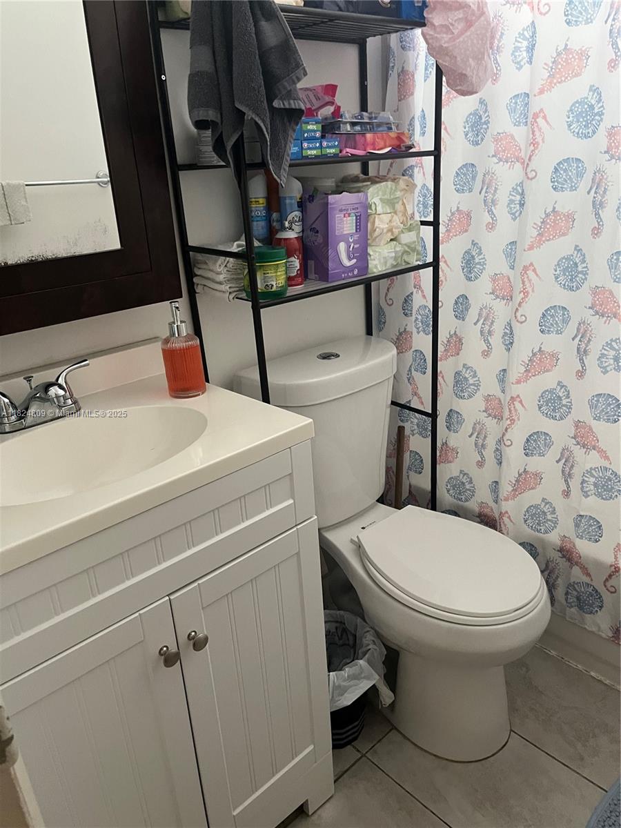 37 Northwest 19th Avenue Miami, FL 33125 - Photo 5 of 9 a bathroom with a sink a toilet and a mirror