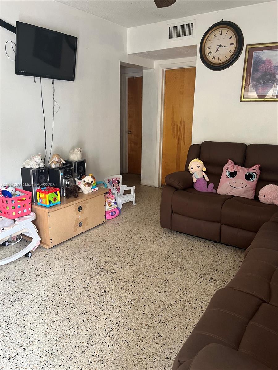 37 Northwest 19th Avenue Miami, FL 33125 - Photo 6 of 9 a living room with baby toys