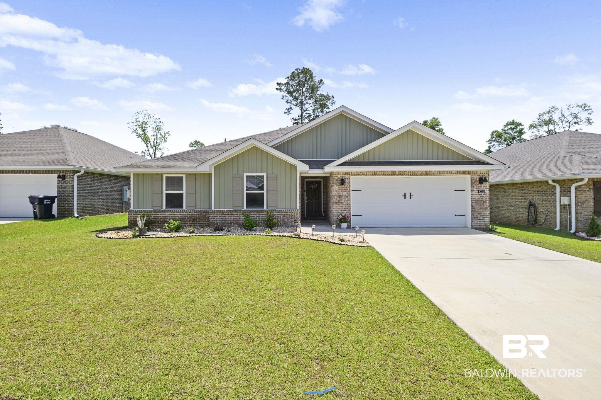 8021 Valor Rdg Way North Mobile, AL 36619 - Photo 1 of 34 Single-story residence featuring a two-car garage, brick and siding exterior, front landscaping, and a concrete driveway