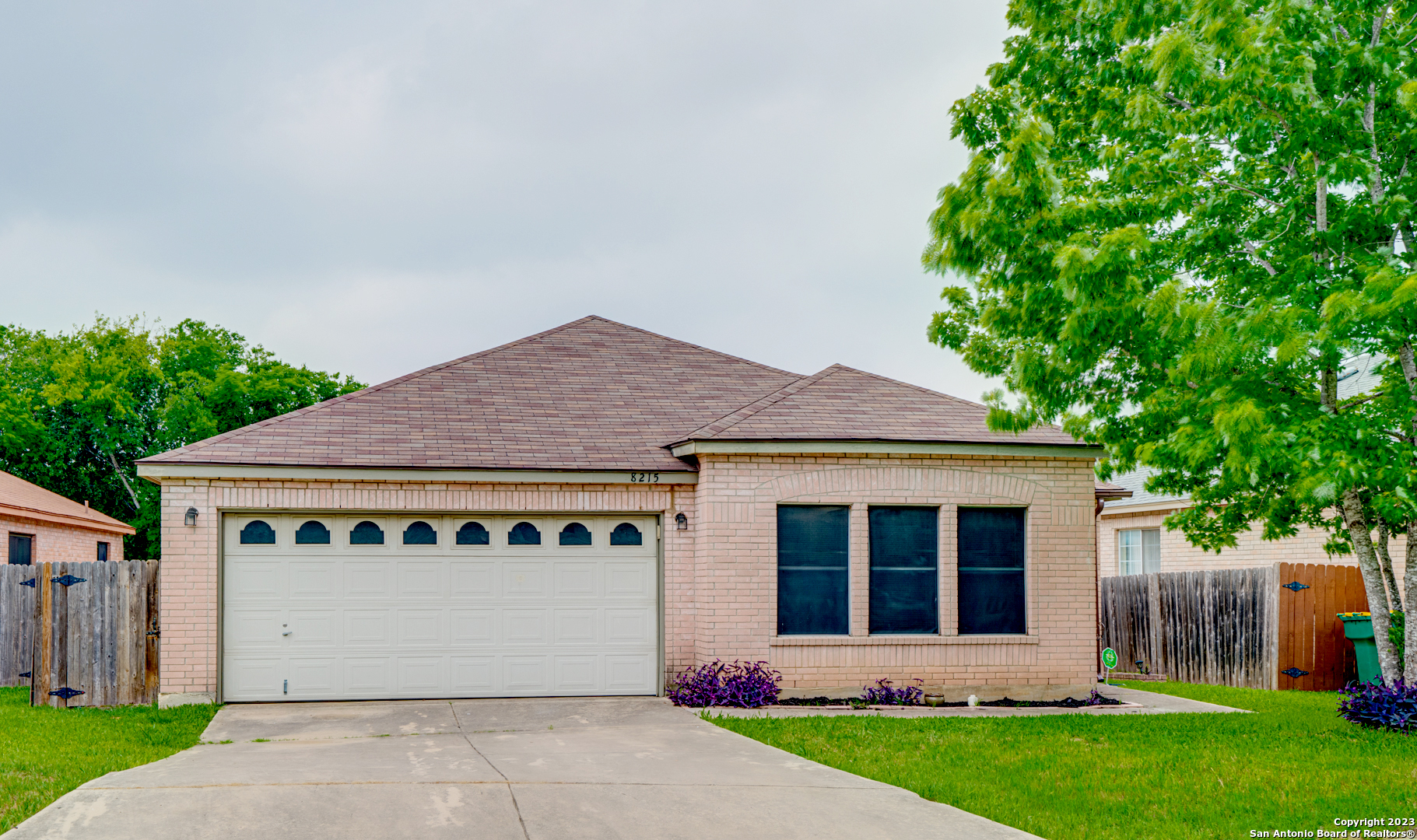 8215 Cherry Glade Converse, TX 78109 - Photo 1 of 1 a front view of a house with a garden and yard