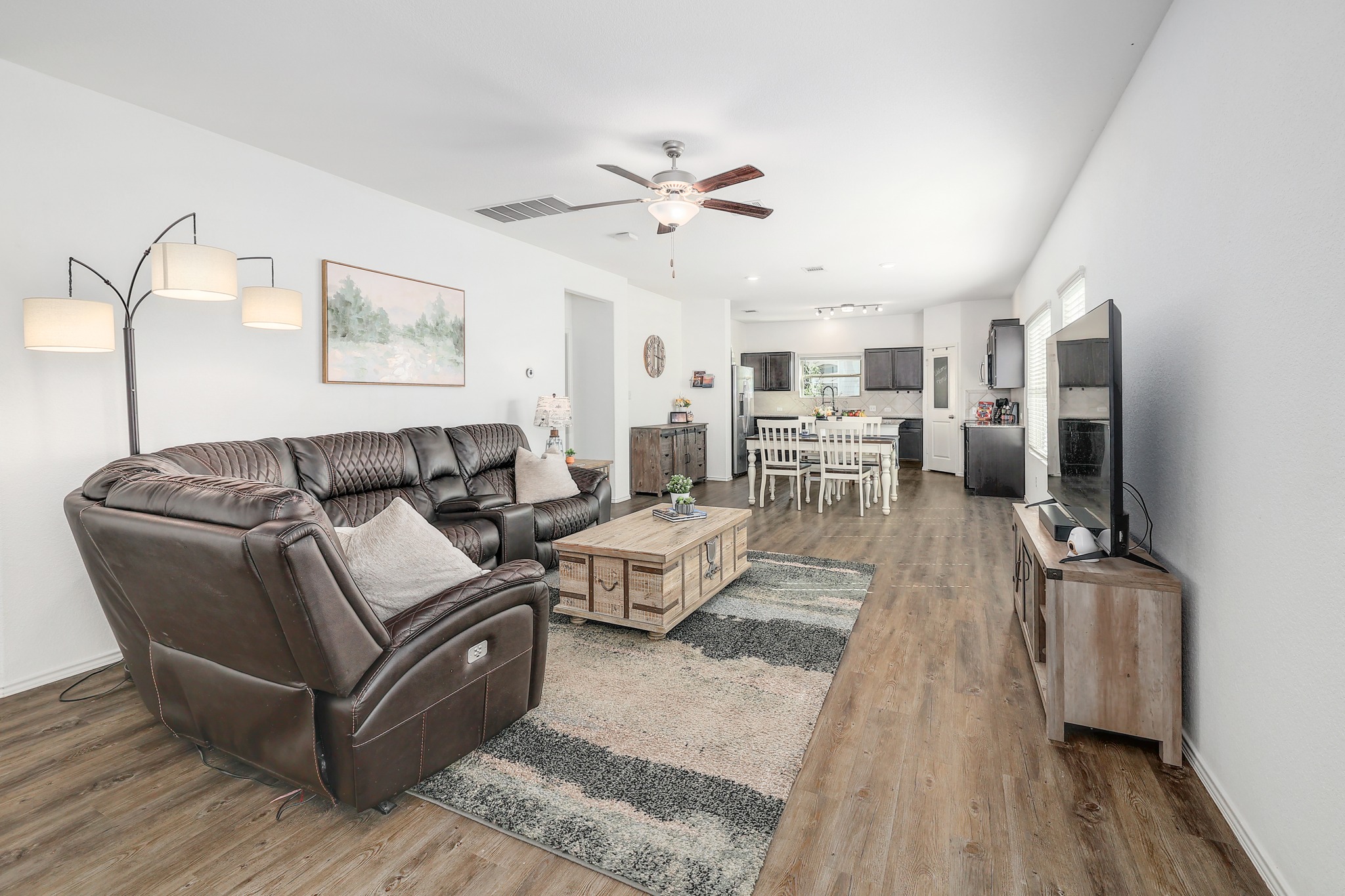 735 Circle Way Jarrell, TX 76537 - Photo 2 of 32 Rich wood-look flooring stretches across this open layout from the living area to the kitchen.