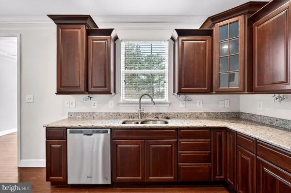 a kitchen with stainless steel appliances granite countertop a sink and cabinets