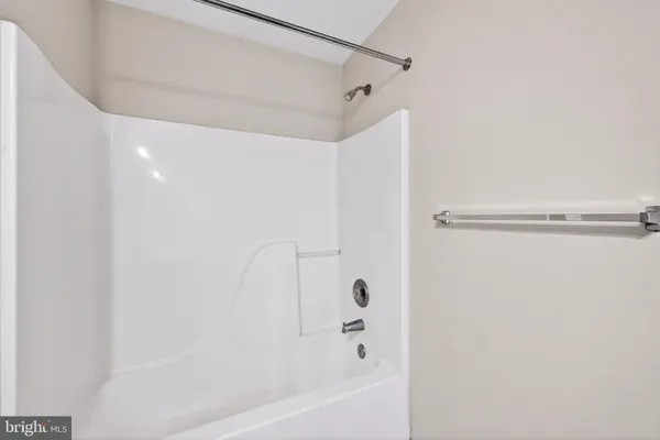 an empty room with a ceiling fan and windows