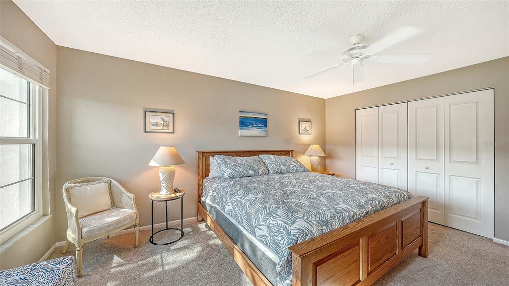 4380 Exeter Drive, Unit H103 Longboat Key, FL 34228 - Photo 21 of 51 a bedroom with a bed and dresser