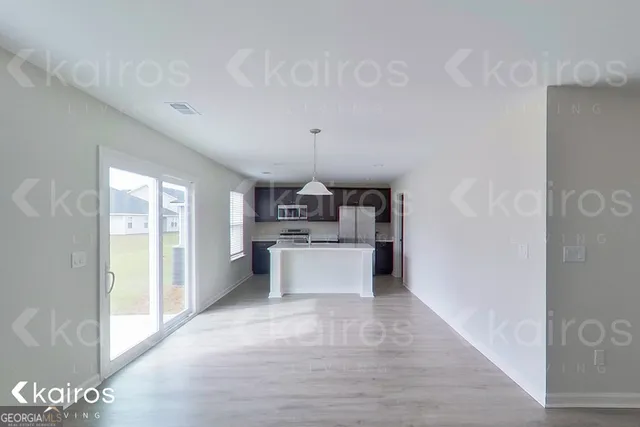 a kitchen with a refrigerator and a sink