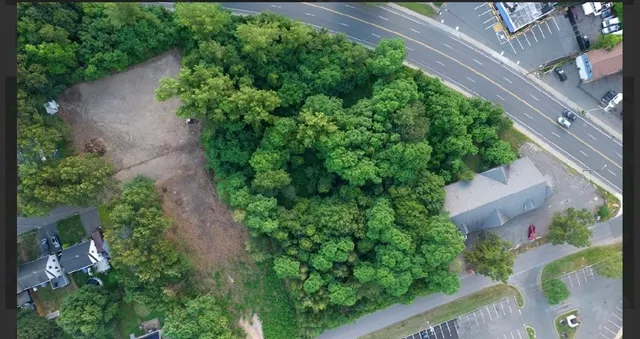 an aerial view of a house with a yard