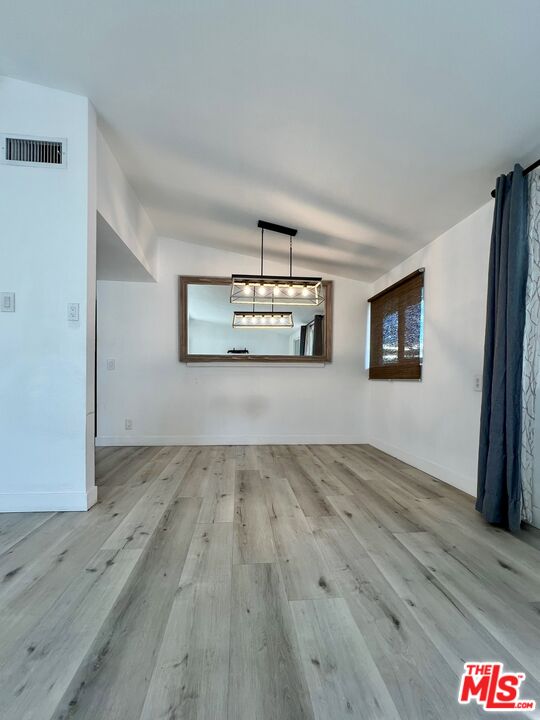 848 West Irving Place Anaheim, CA 92805 - Photo 11 of 33 a view of a room with wooden floor and a window