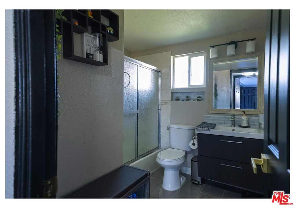 848 West Irving Place Anaheim, CA 92805 - Photo 19 of 33 a bathroom with a toilet sink and mirror