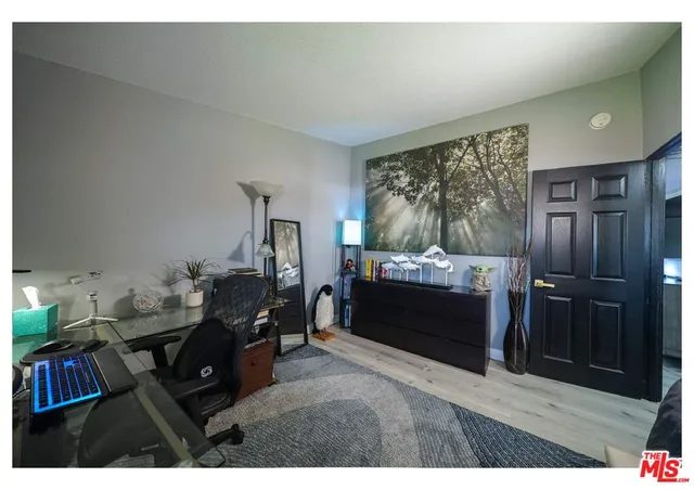 a living room with furniture a flat screen tv and a floor to ceiling window