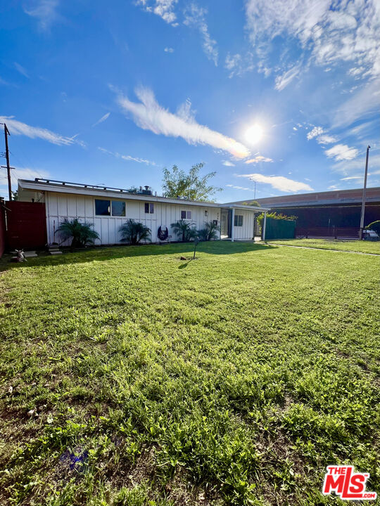 848 West Irving Place Anaheim, CA 92805 - Photo 31 of 33 a view of a swimming pool with an outdoor seating and a yard