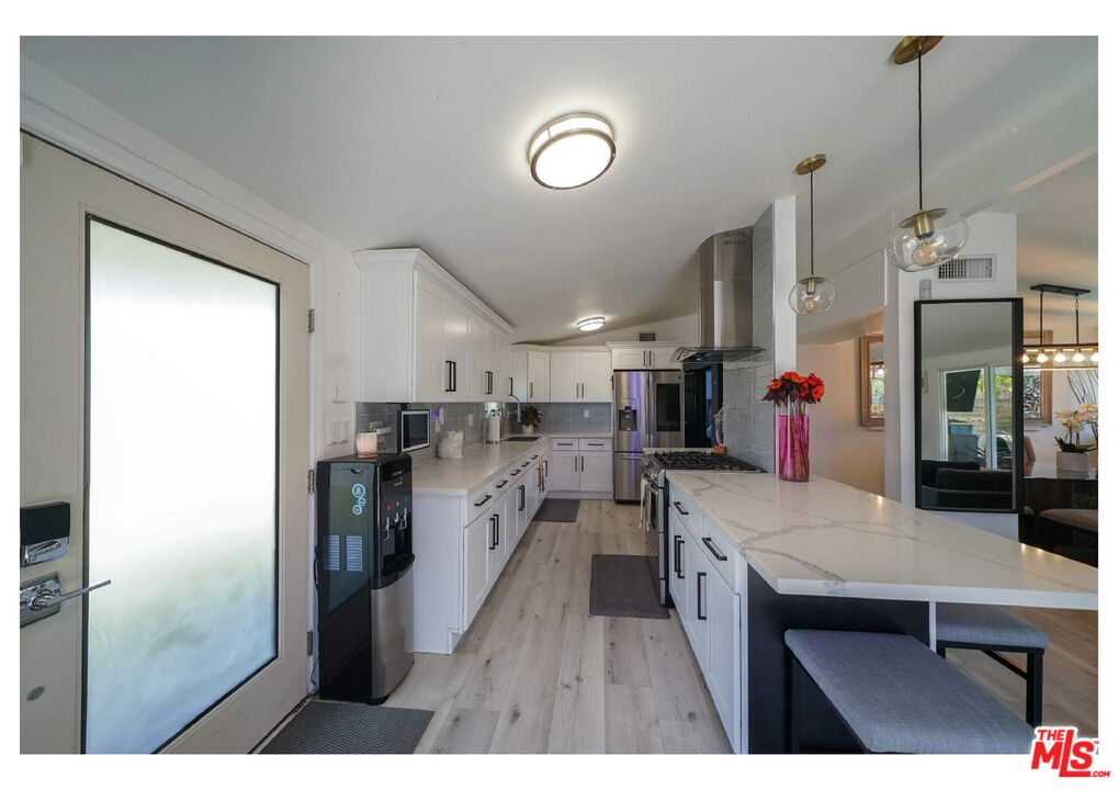 848 West Irving Place Anaheim, CA 92805 - Photo 4 of 33 a kitchen with refrigerator and cabinets