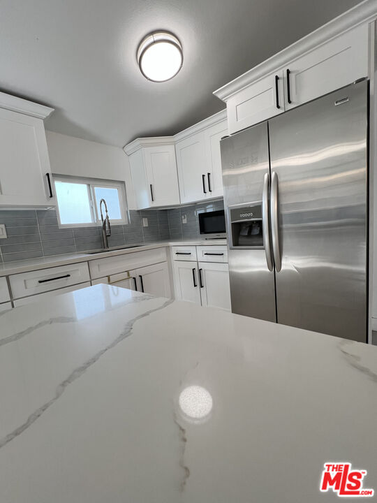 848 West Irving Place Anaheim, CA 92805 - Photo 6 of 33 a kitchen with stainless steel appliances granite countertop a sink a stove and a refrigerator