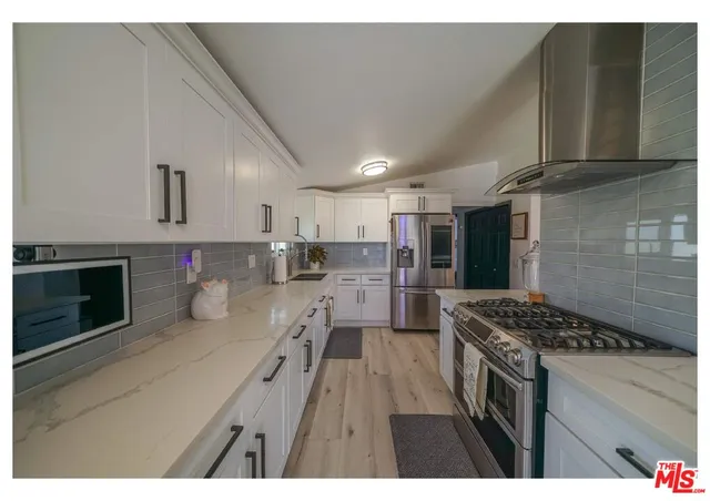 a kitchen with refrigerator and stove