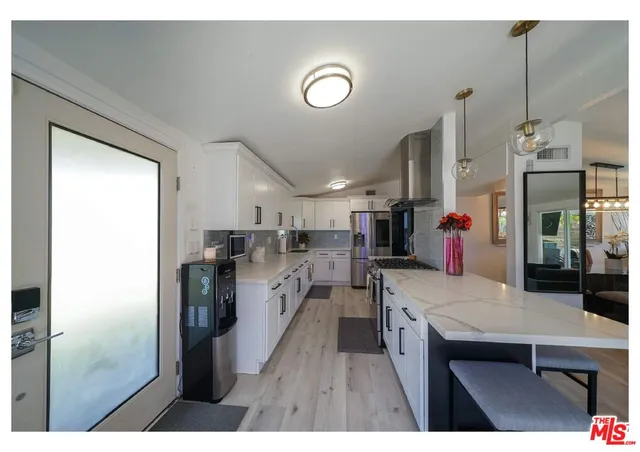 a kitchen with refrigerator and cabinets