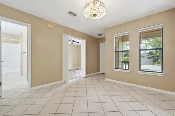 an empty room with windows and closet