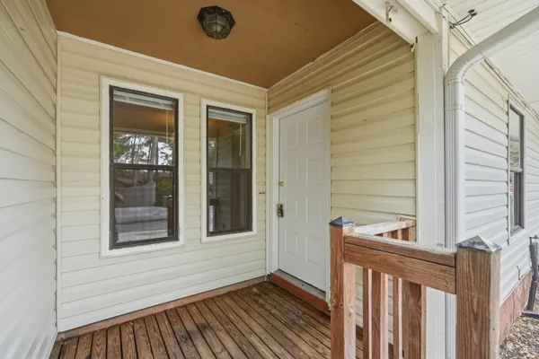 a view of a porch with wooden floor