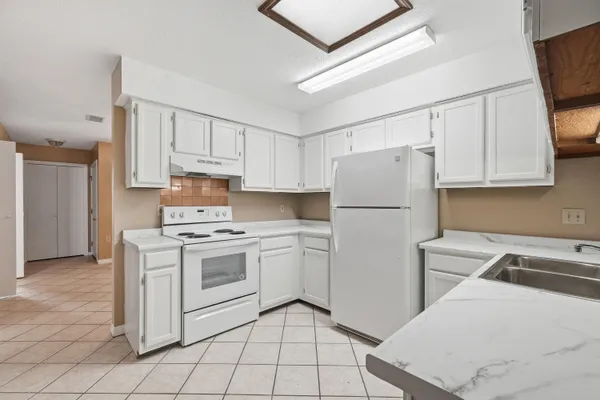 a kitchen with a stove sink and refrigerator