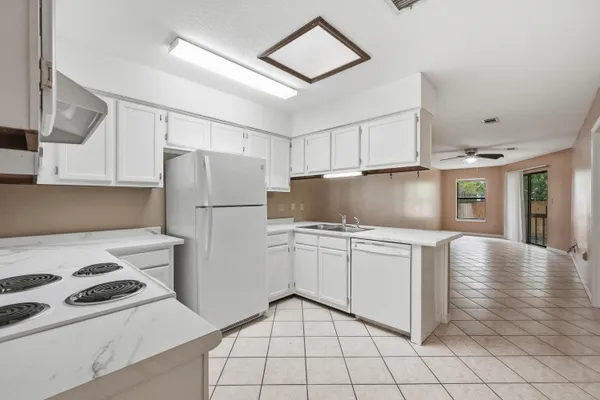 a kitchen with a stove a refrigerator and a sink