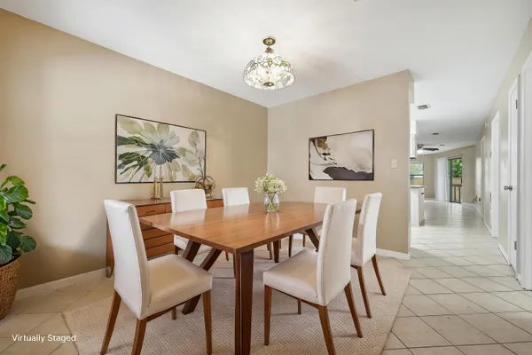 a view of a dining room with furniture and a potted plant