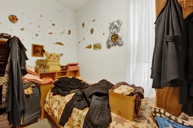 a bed room with a bed and a blue curtain