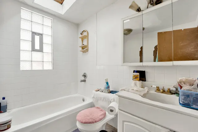 a bathroom with a sink toilet tub and shower