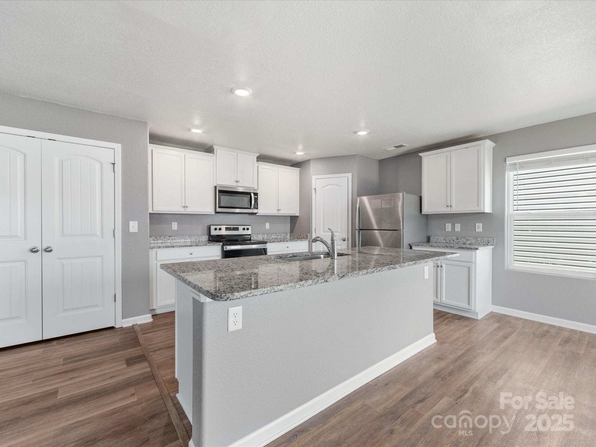 9136 Creedmore Hills Drive Charlotte, NC 28214 - Photo 15 of 48 a kitchen with stainless steel appliances granite countertop a sink refrigerator and cabinets