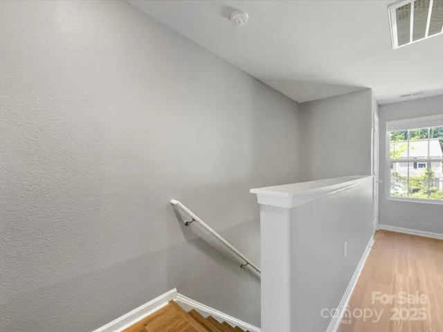 a view of storage and utility room with wooden floor