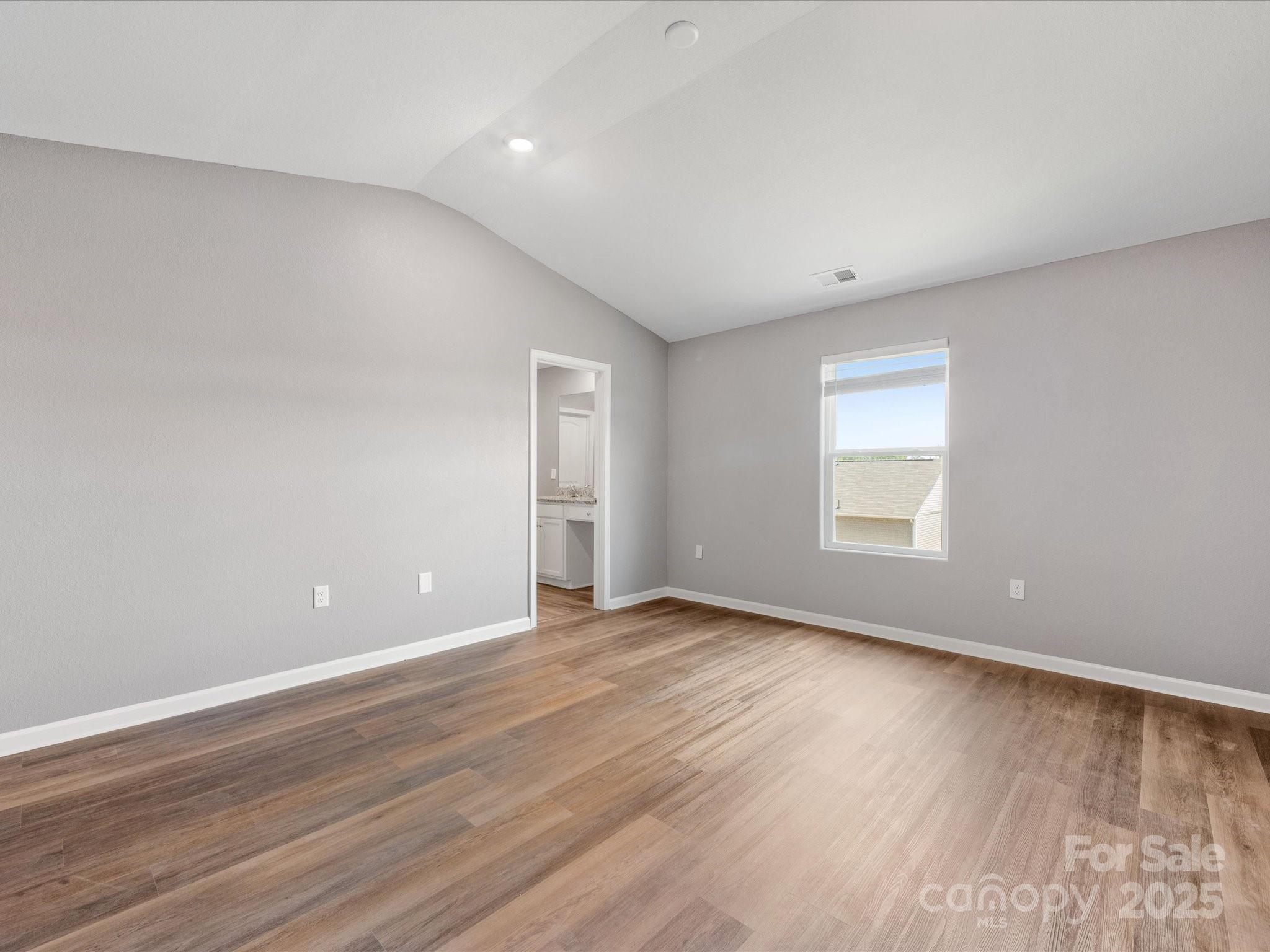 9136 Creedmore Hills Drive Charlotte, NC 28214 - Photo 30 of 48 a view of an empty room with wooden floor and a window