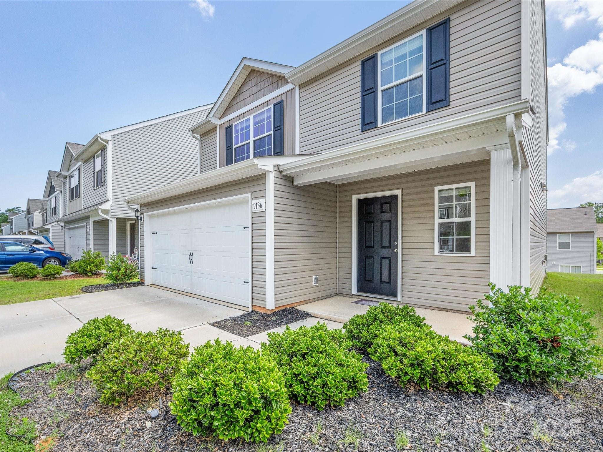9136 Creedmore Hills Drive Charlotte, NC 28214 - Photo 3 of 48 a front view of a house with garden
