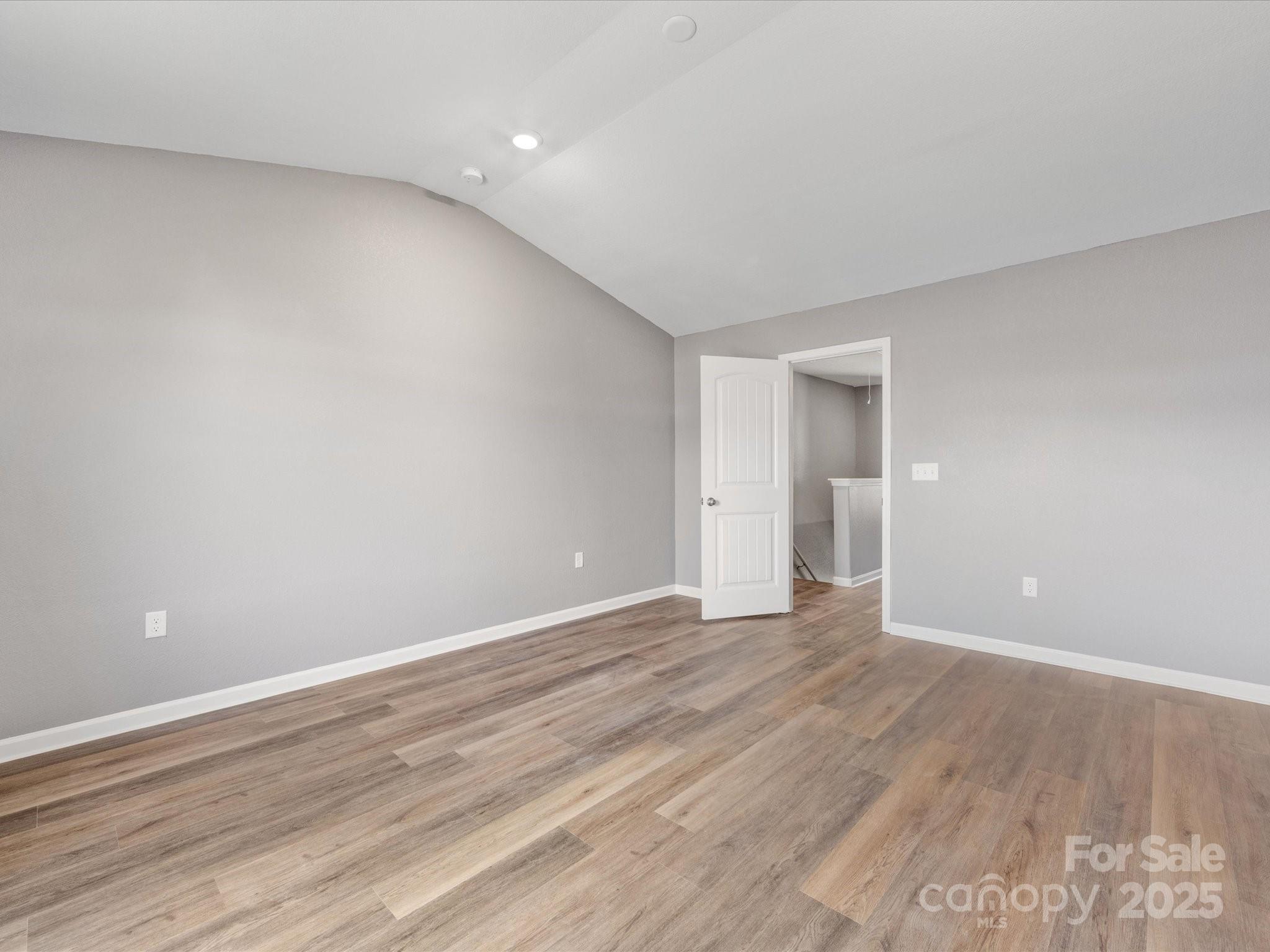 9136 Creedmore Hills Drive Charlotte, NC 28214 - Photo 31 of 48 a view of an empty room with wooden floor and a window