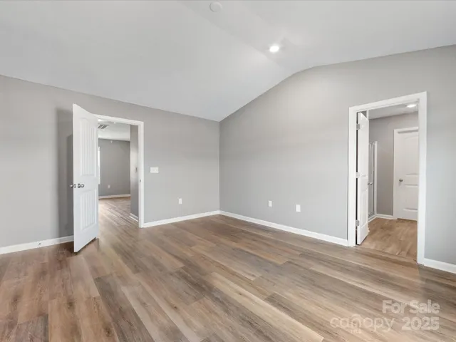 a view of an empty room and wooden floor