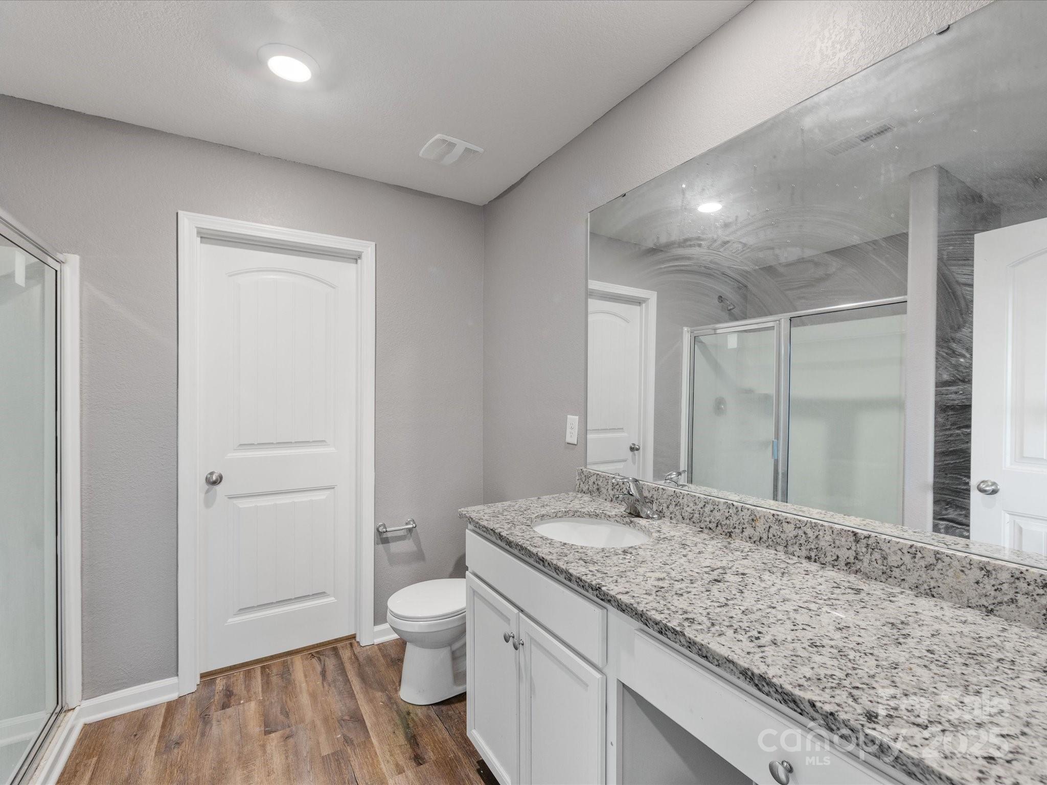 9136 Creedmore Hills Drive Charlotte, NC 28214 - Photo 33 of 48 a bathroom with a granite countertop sink a toilet and shower