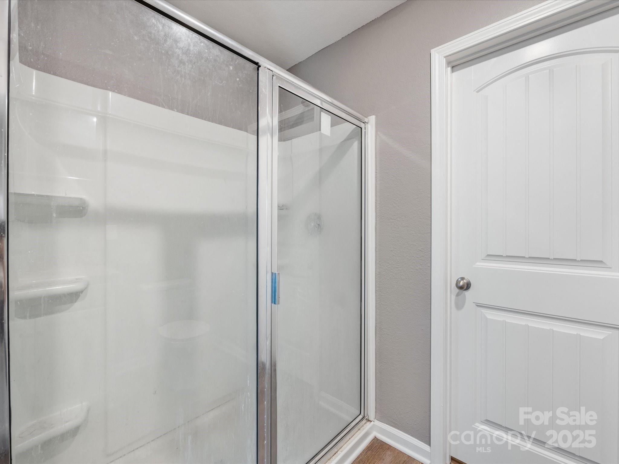 9136 Creedmore Hills Drive Charlotte, NC 28214 - Photo 34 of 48 a bathroom with a glass shower door