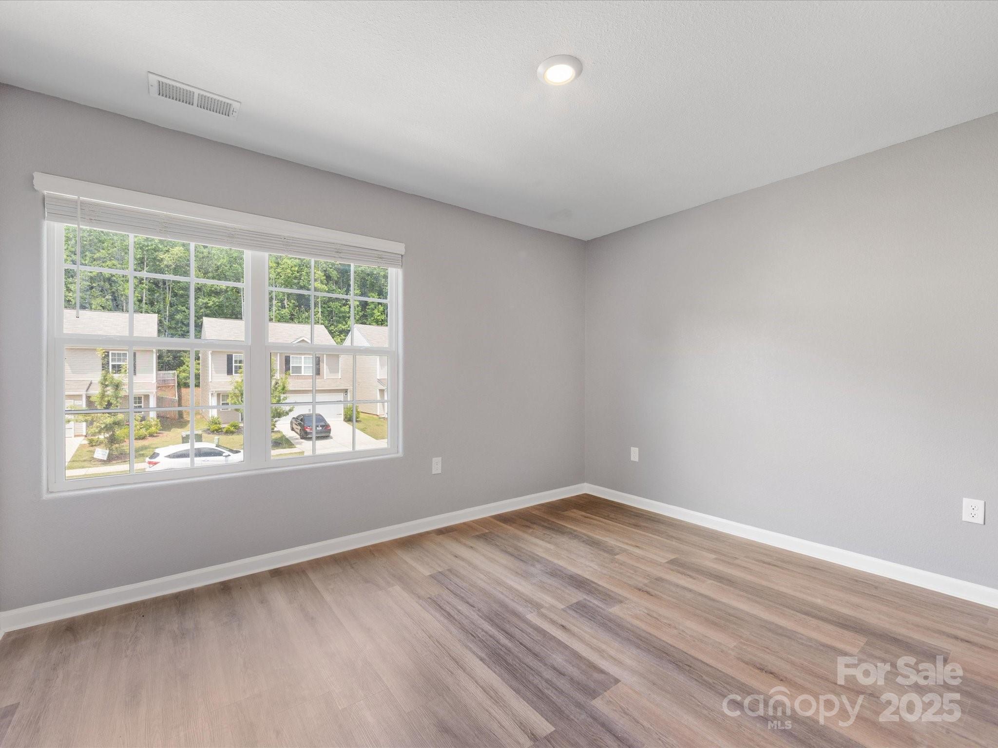 9136 Creedmore Hills Drive Charlotte, NC 28214 - Photo 37 of 48 an empty room with wooden floor and windows
