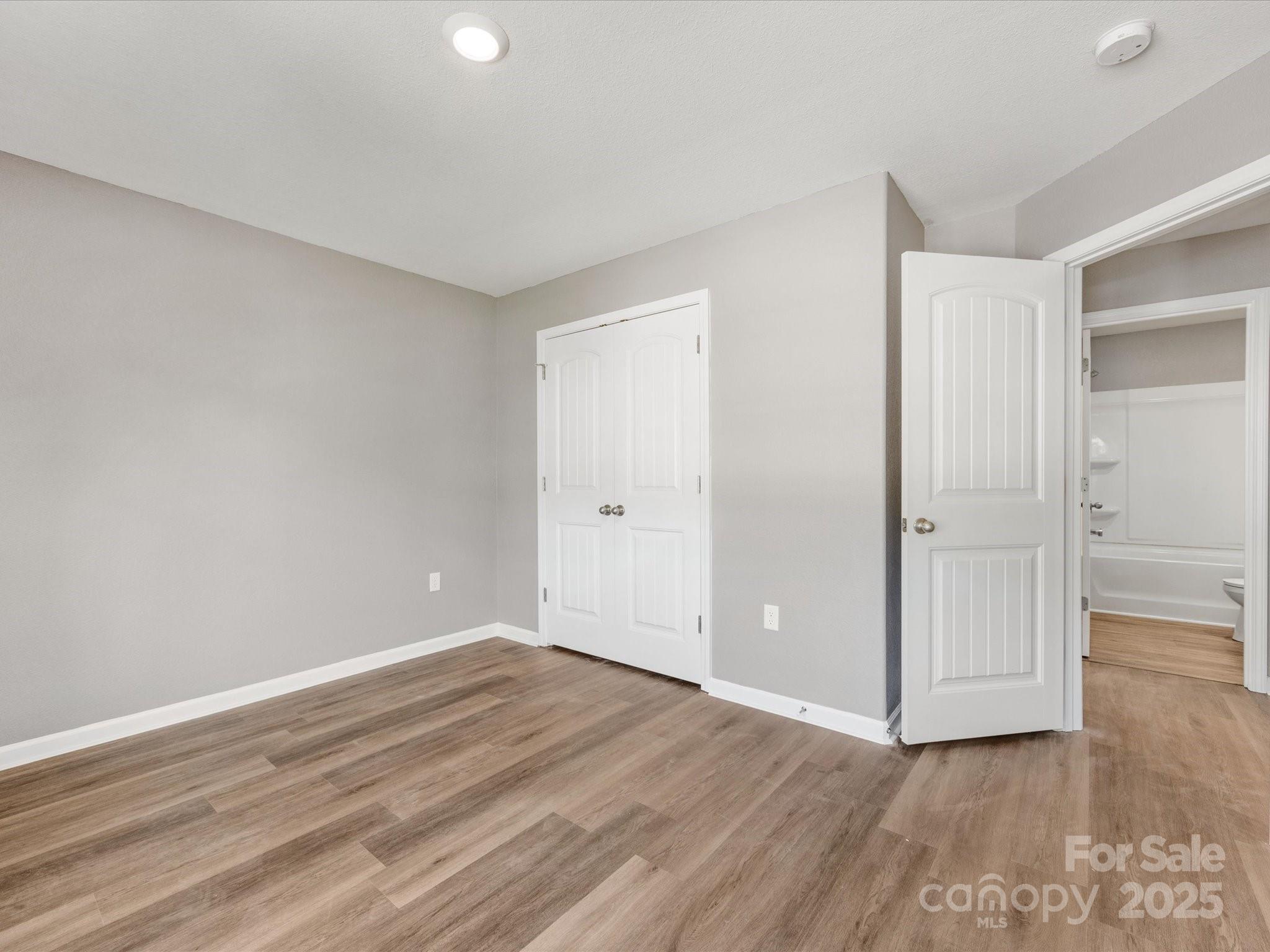 9136 Creedmore Hills Drive Charlotte, NC 28214 - Photo 39 of 48 a view of an empty room with wooden floor and closet