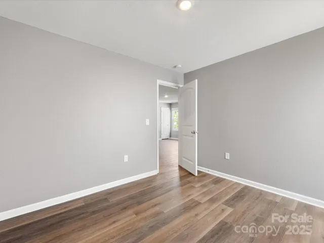 a view of an empty room and wooden floor
