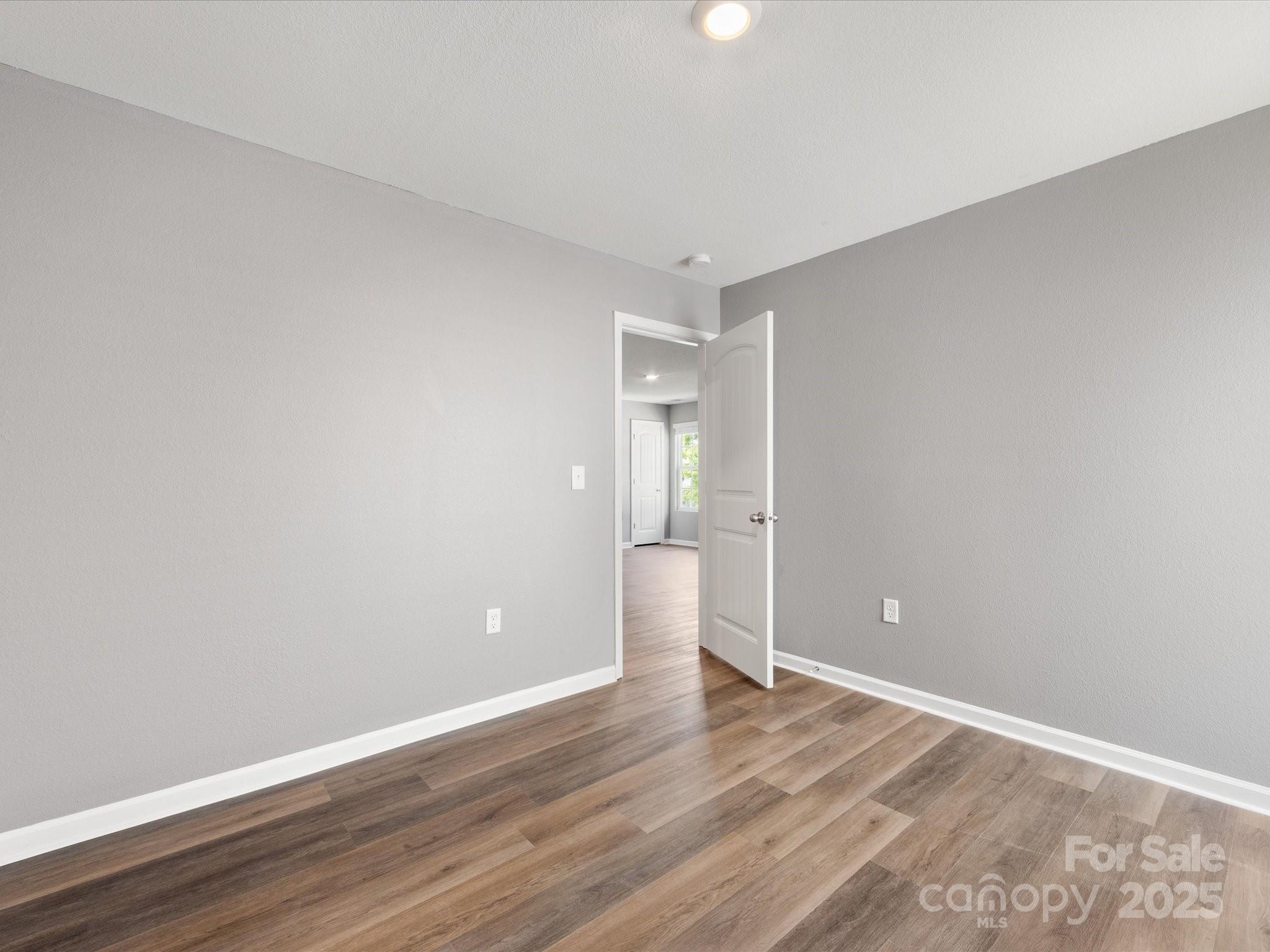 9136 Creedmore Hills Drive Charlotte, NC 28214 - Photo 44 of 48 a view of an empty room and wooden floor