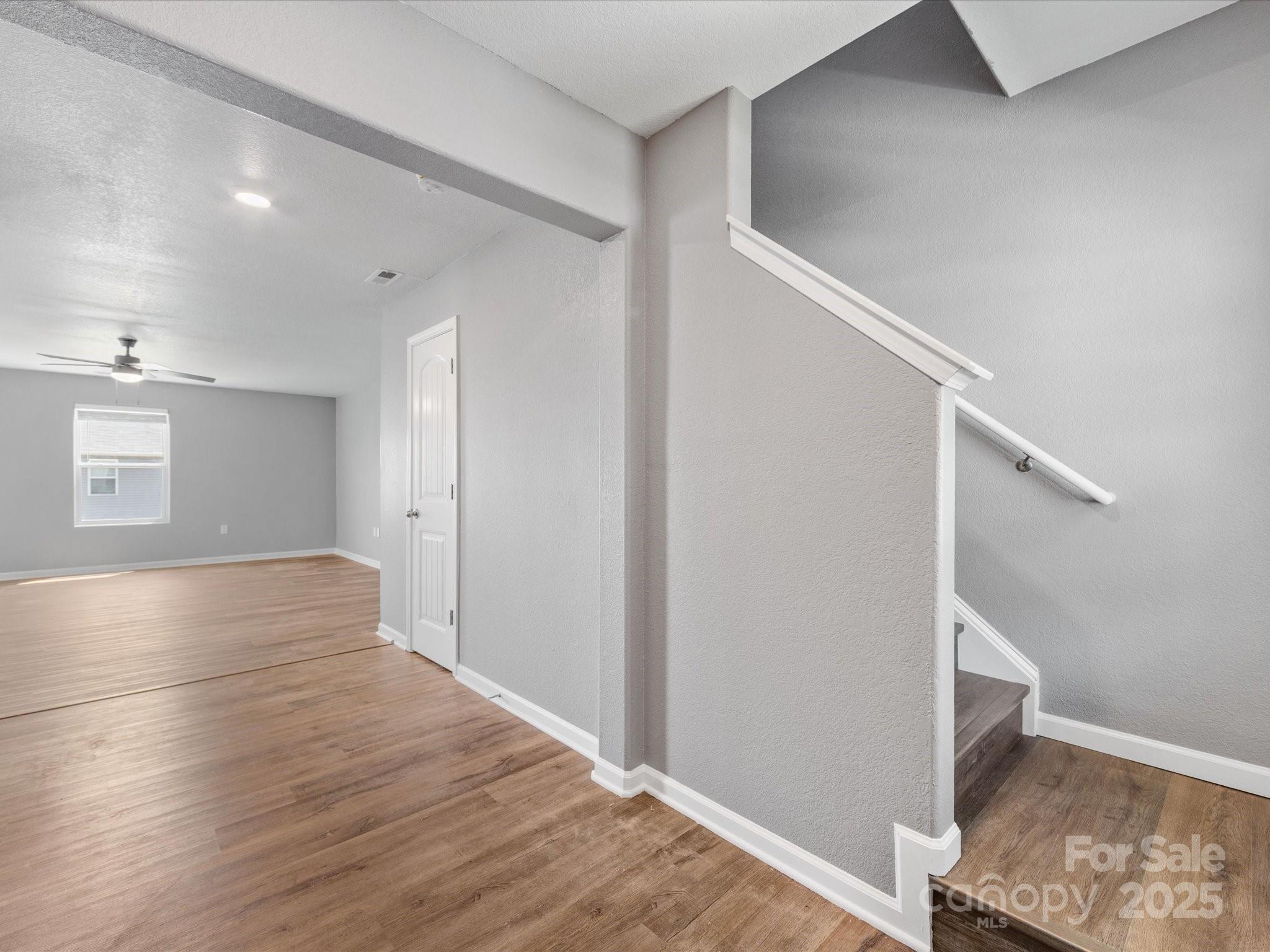 9136 Creedmore Hills Drive Charlotte, NC 28214 - Photo 6 of 48 a view of an empty room with wooden floor and a window