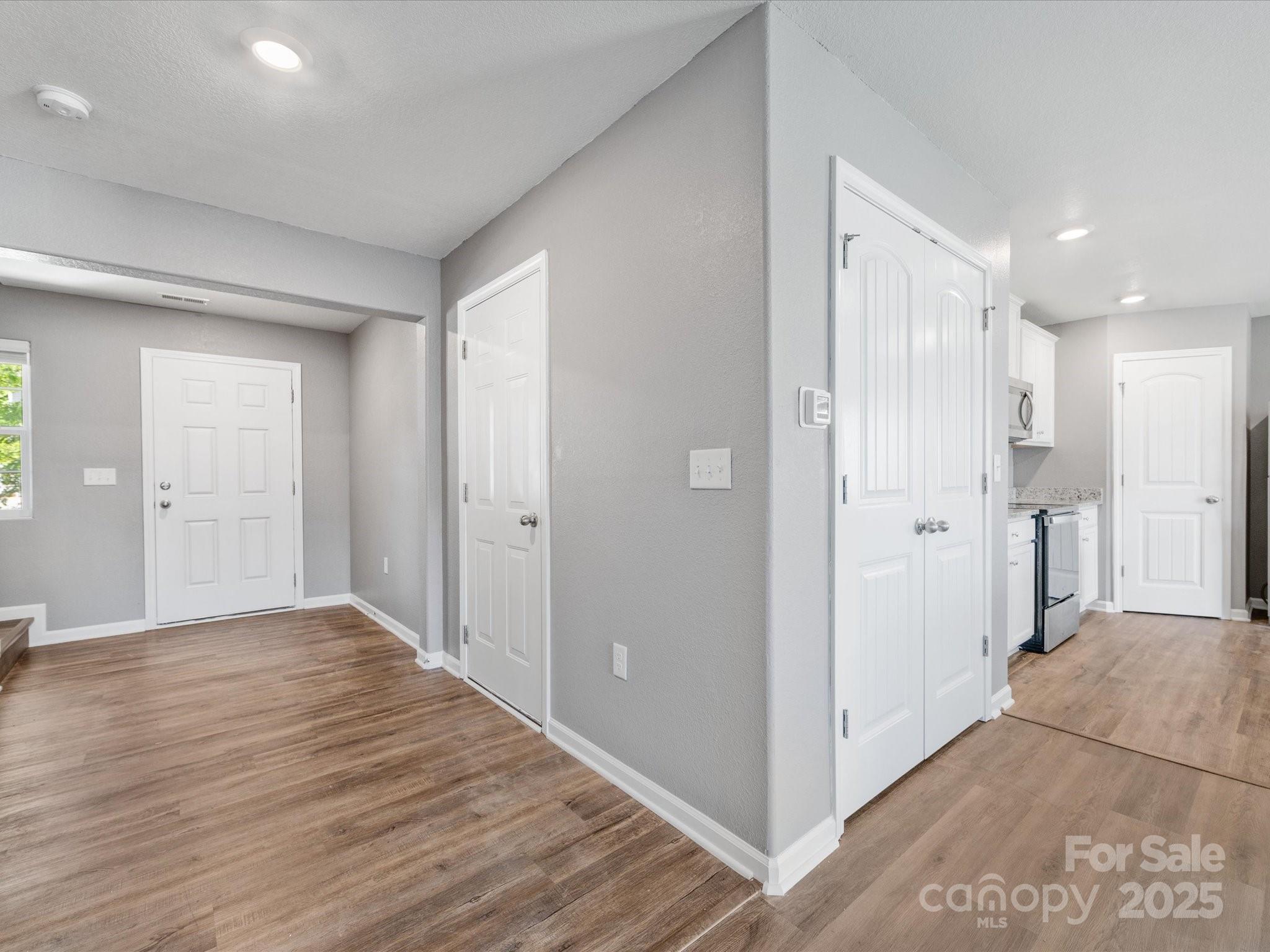 9136 Creedmore Hills Drive Charlotte, NC 28214 - Photo 7 of 48 a view of a hallway with wooden floor