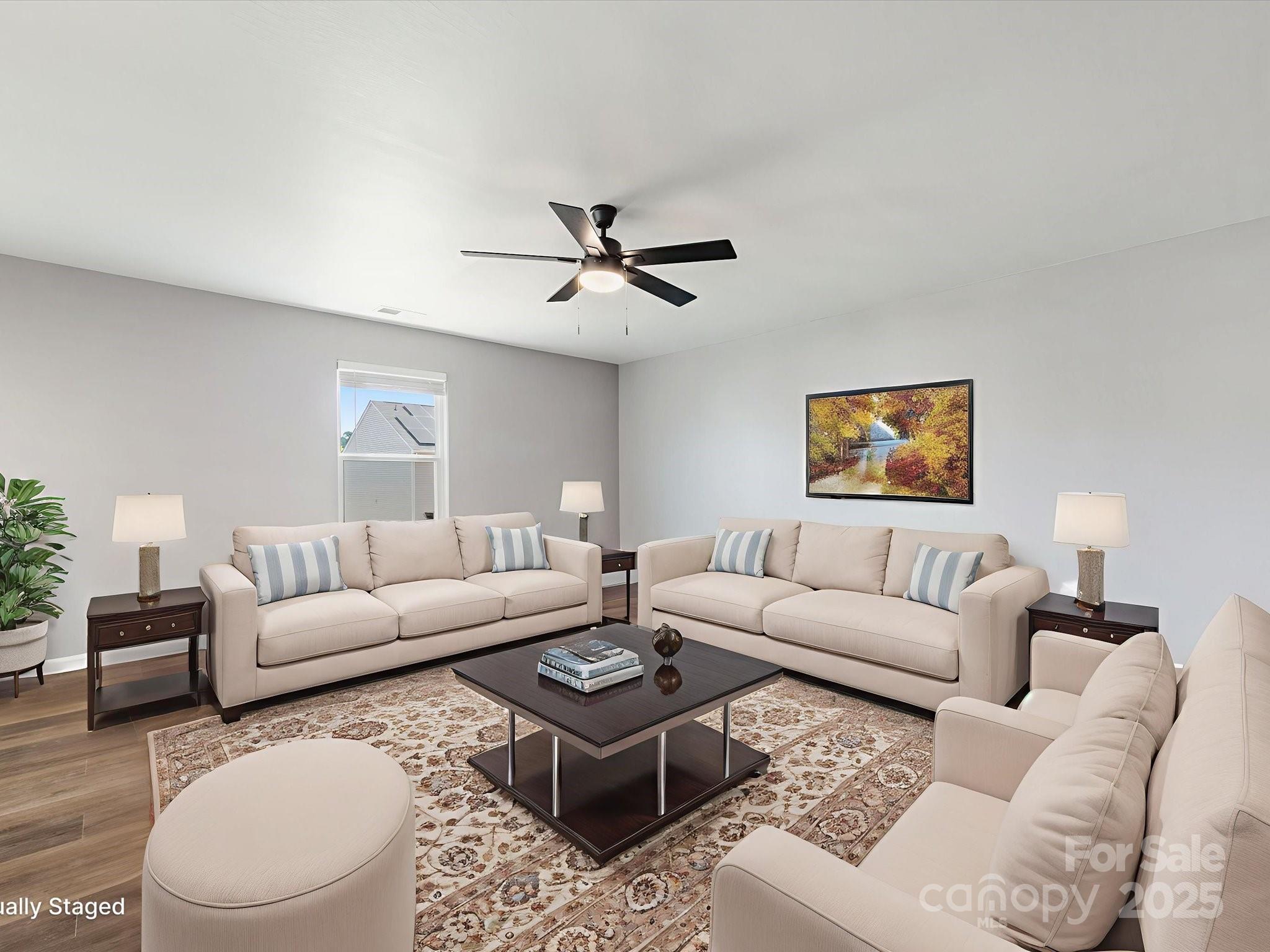 9136 Creedmore Hills Drive Charlotte, NC 28214 - Photo 9 of 48 a living room with furniture a ceiling fan a lamp and a window