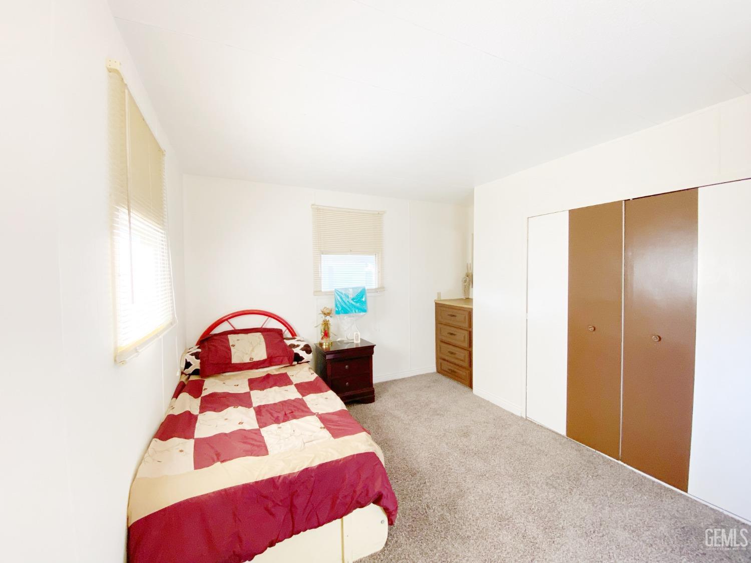 Undisclosed Address Bakersfield, CA 93301 - Photo 11 of 16 a bedroom with a bed and a painting on the wall