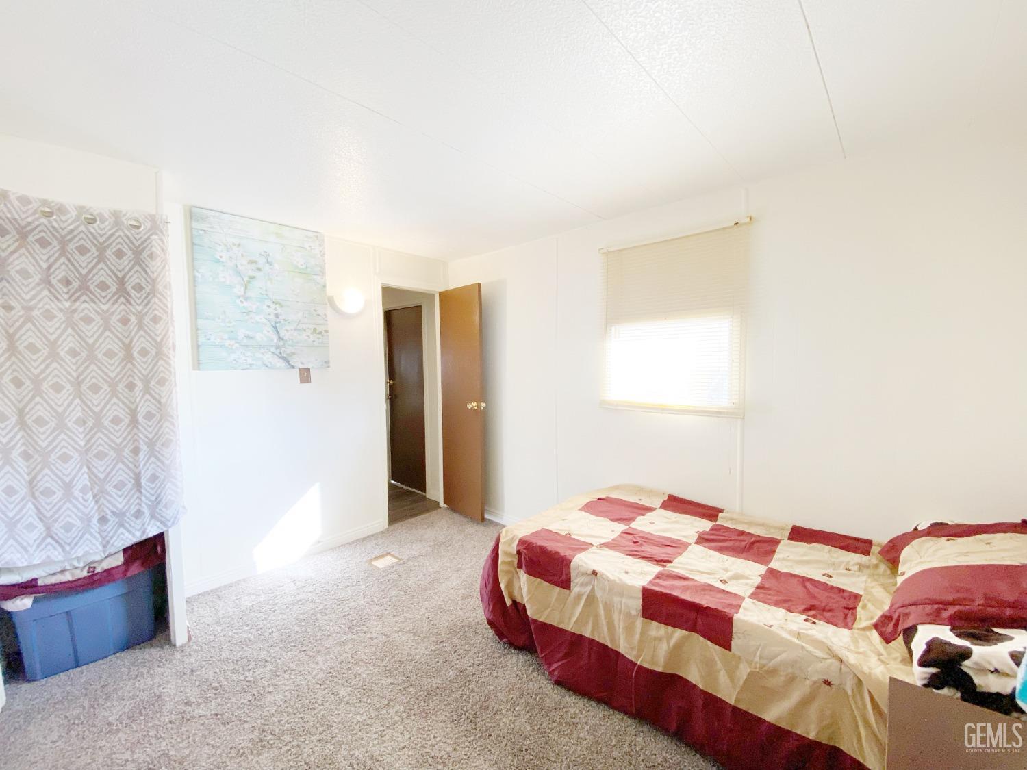 Undisclosed Address Bakersfield, CA 93301 - Photo 12 of 16 a bedroom with a bed and a couch