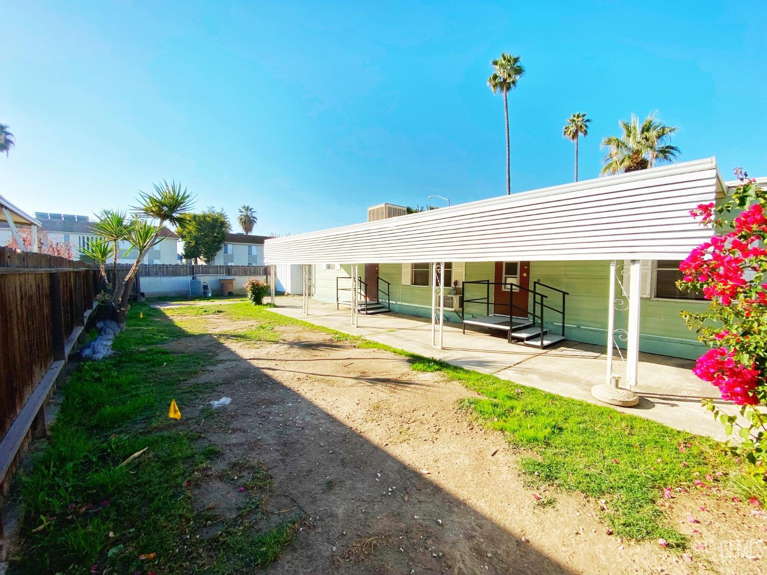 Undisclosed Address Bakersfield, CA 93301 - Photo 16 of 16 a view of a house with swimming pool and a porch