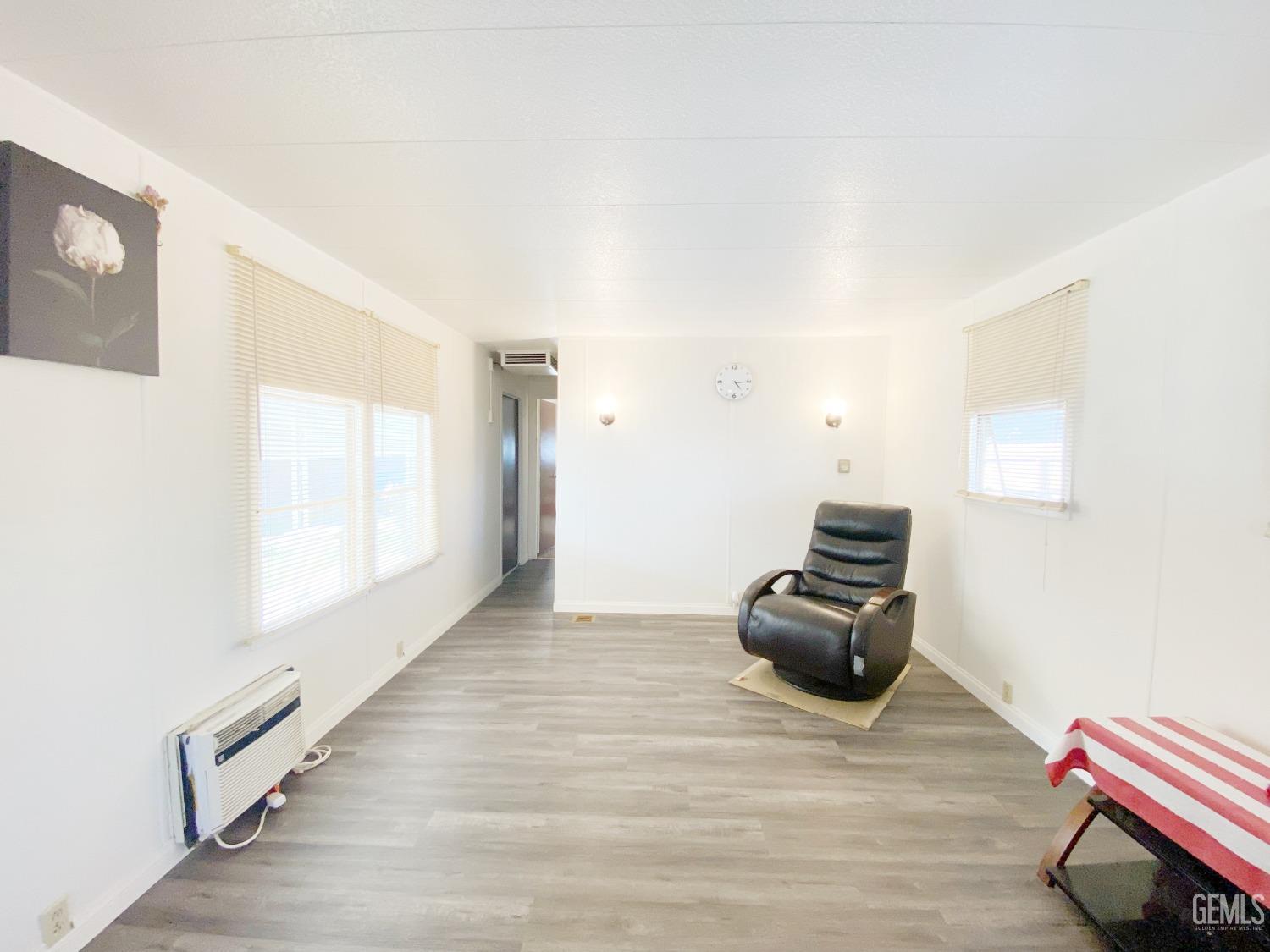 Undisclosed Address Bakersfield, CA 93301 - Photo 6 of 16 a room with a hardwood floor and a window