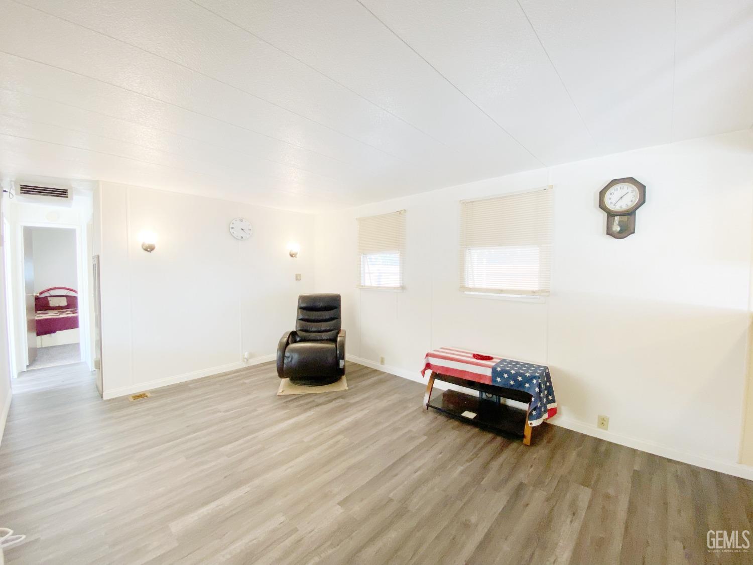 Undisclosed Address Bakersfield, CA 93301 - Photo 7 of 16 a room with furniture and a wooden floor