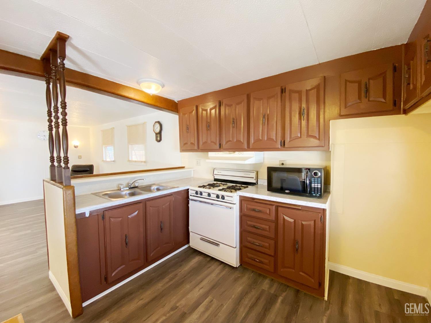 Undisclosed Address Bakersfield, CA 93301 - Photo 8 of 16 a kitchen with a stove a sink and a refrigerator