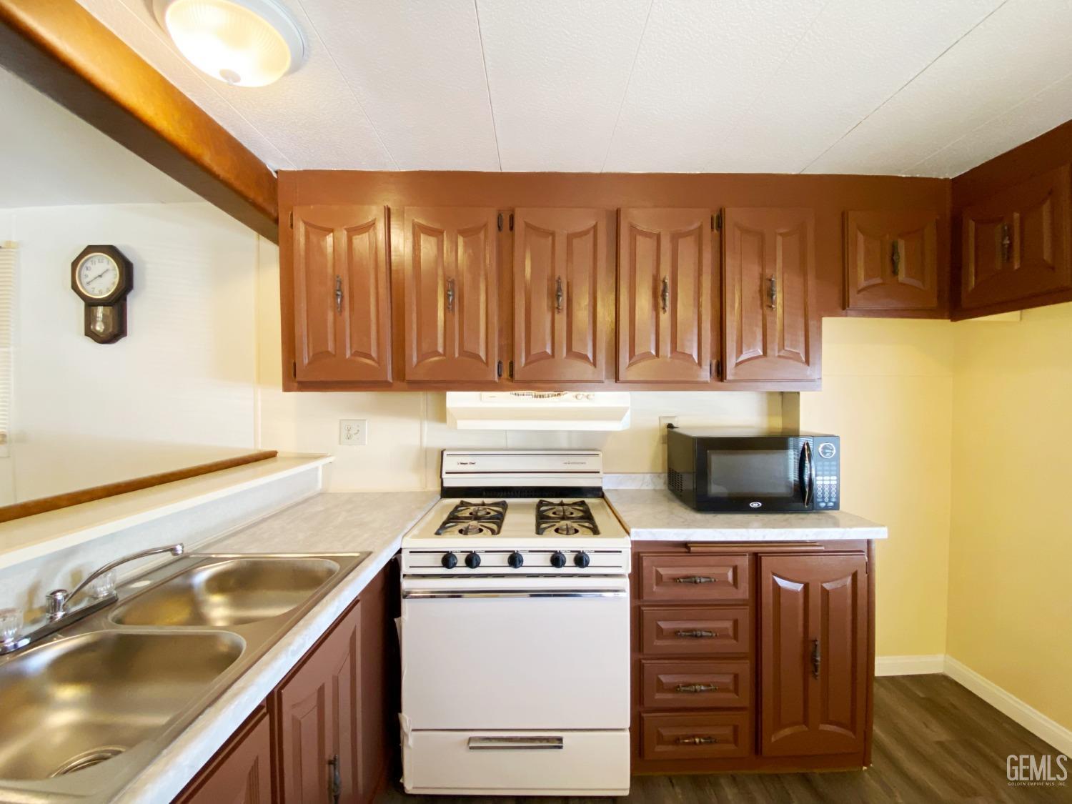 Undisclosed Address Bakersfield, CA 93301 - Photo 9 of 16 a kitchen with a stove and a sink