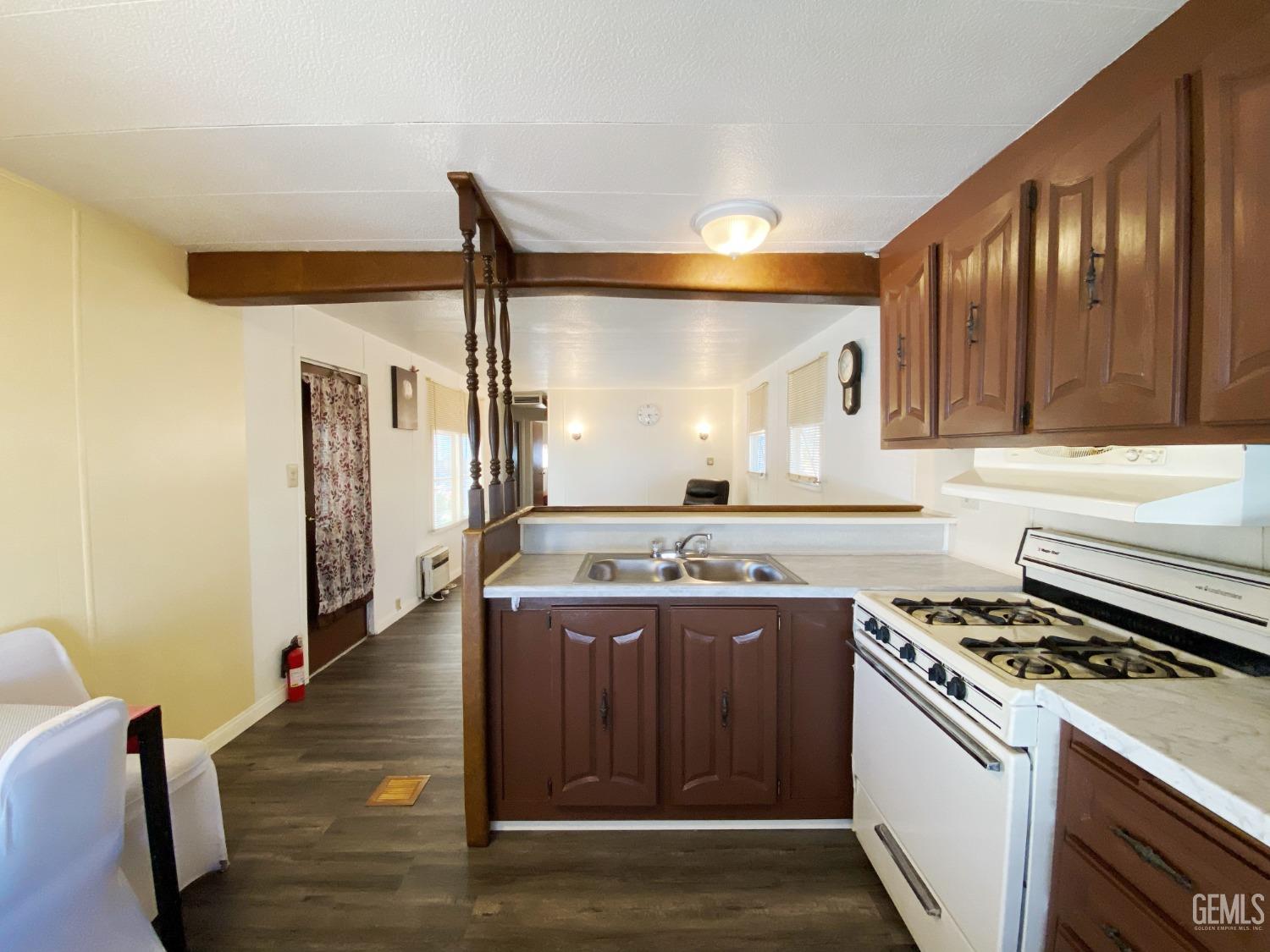 Undisclosed Address Bakersfield, CA 93301 - Photo 10 of 16 a kitchen with a stove and a refrigerator